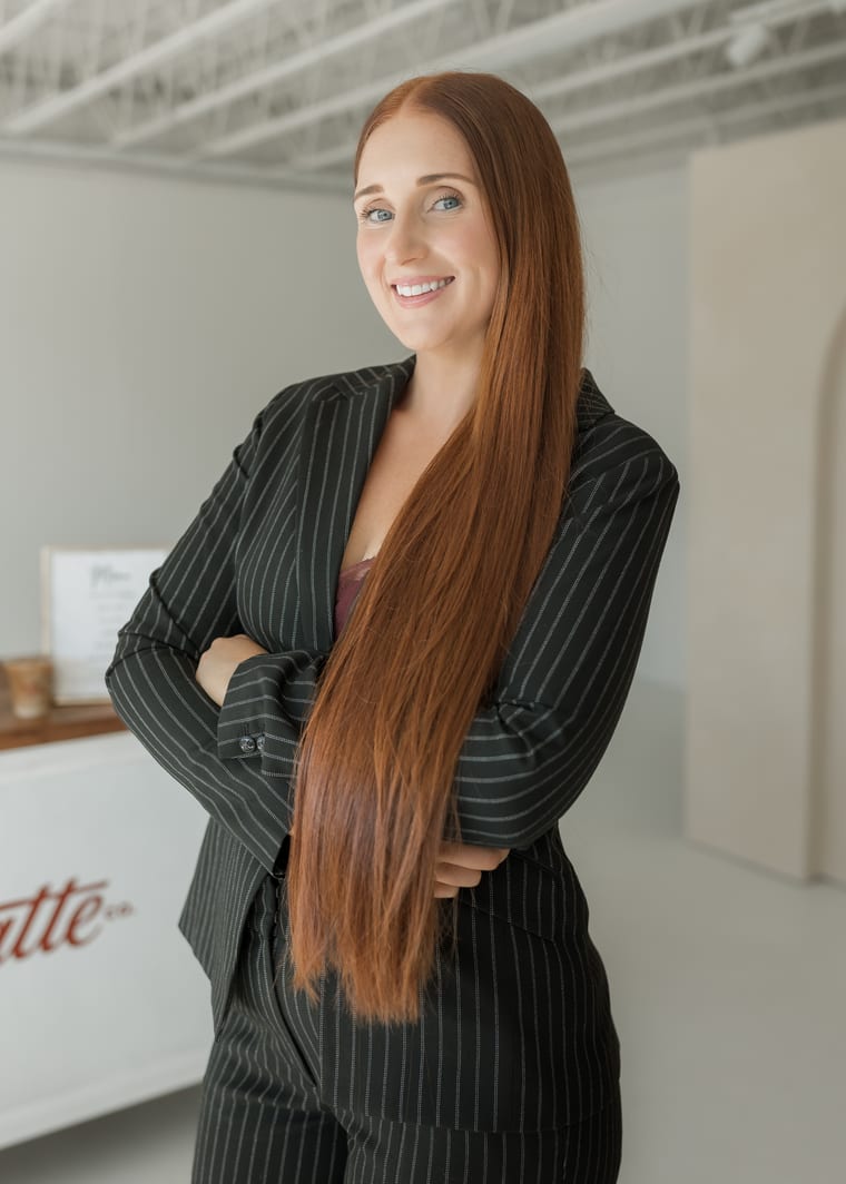 Julia, the owner of Love and Latte, standing beside the cart